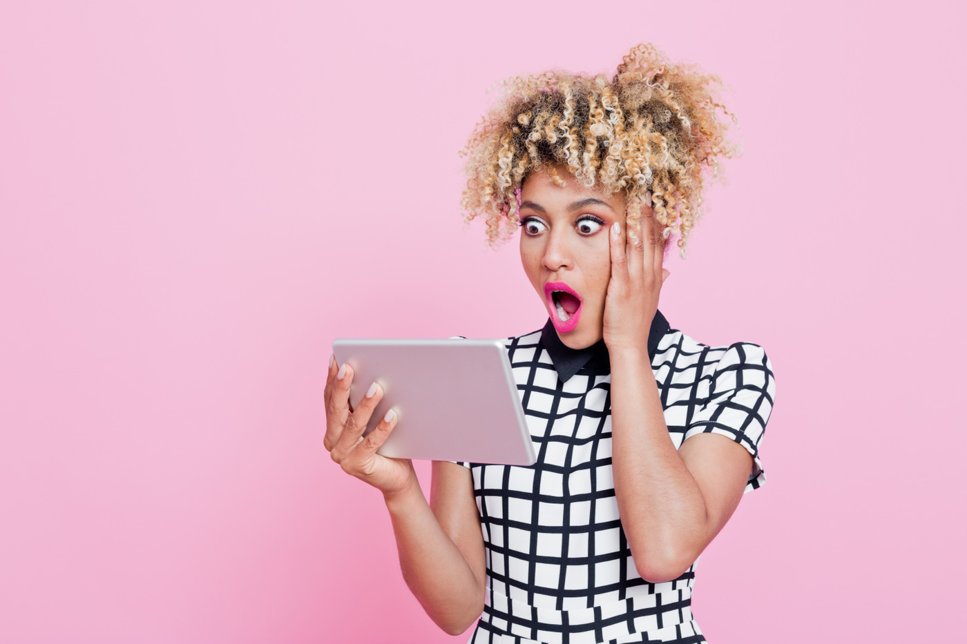 Shocked expression on woman with tablet